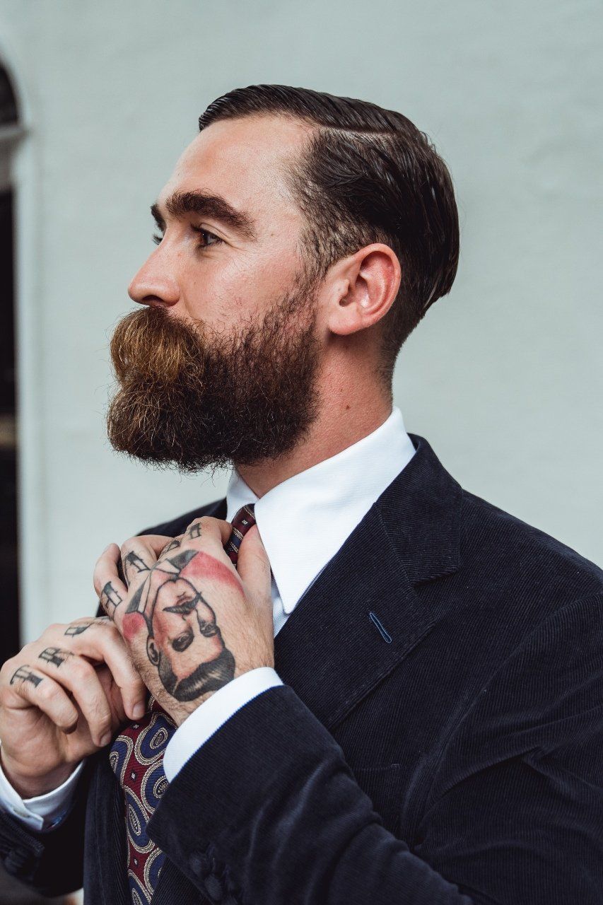 Adam Davies, founder and tailor of Adam James Bespoke, wears a form-fitting corduroy suit jacket with bespoke inner-lining - from Adam James Bespoke's Vegan business range