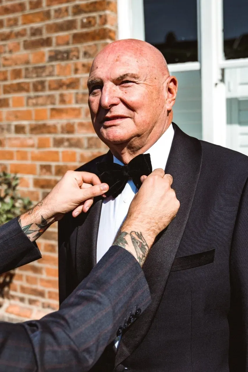 Look the part with a formal tailored suit from Adam James Bespoke. Pictured: a gent wears a custom tuxedo for a wedding
