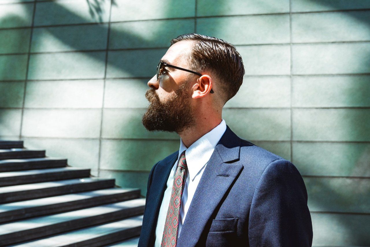 Adam Davies, founder of Adam James Bespoke tailoring, wears a dark blue medium-weight business suit in central London