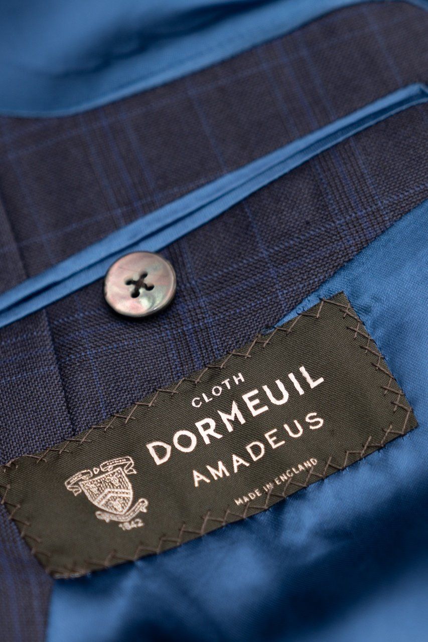 A client wears an effortlessly chic combination of business separates from Adam James Bespoke