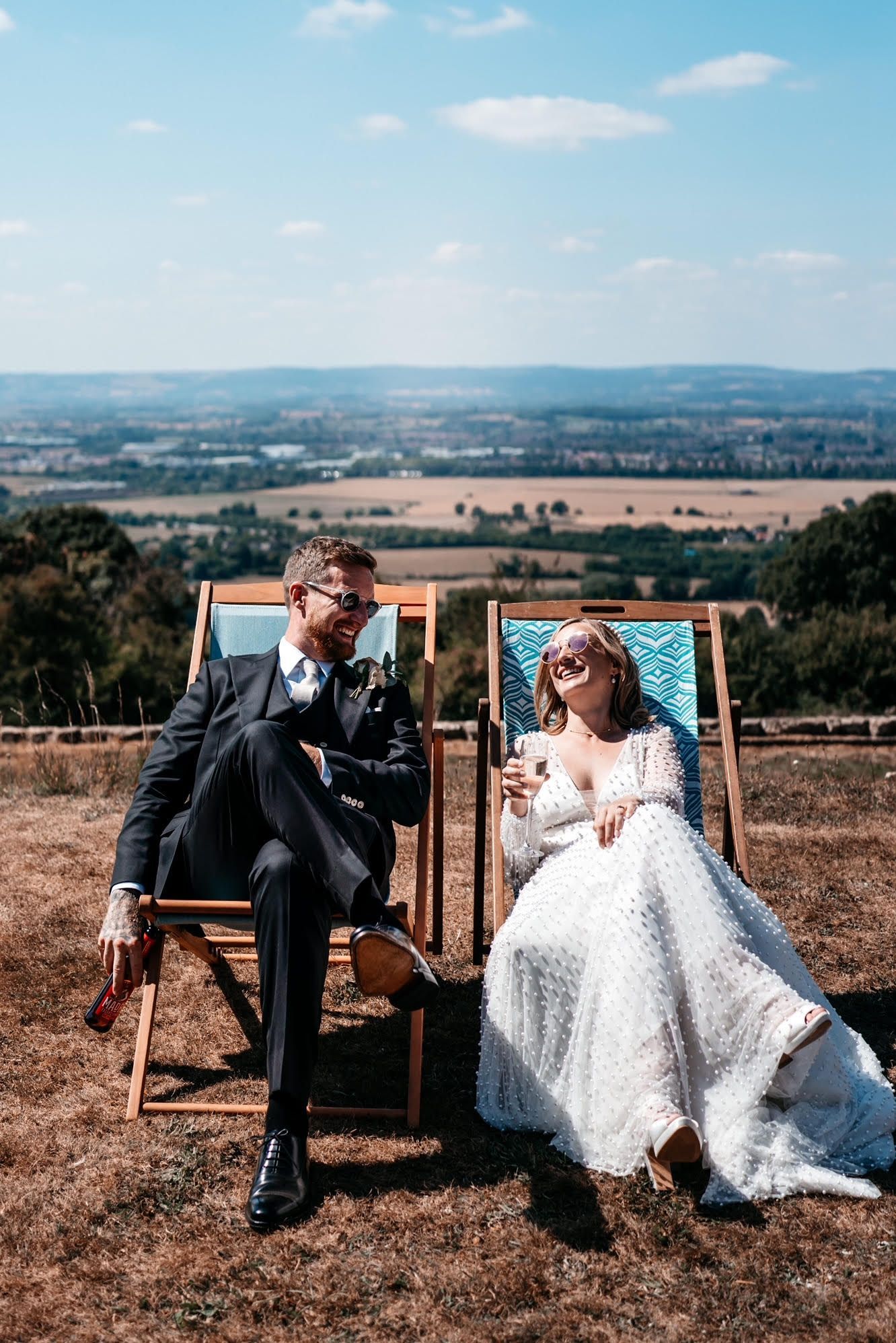 A happy groom wears a black bamboo suit on his wedding day, handmade by Adam James Bespoke