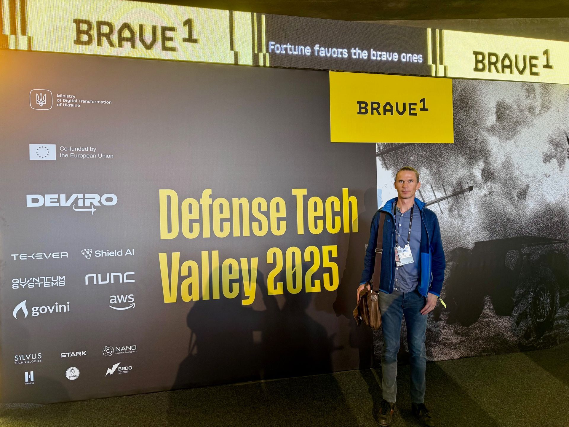 Michael Hübner of ua.ventures in front of the Defense Tech Valley 2025 sign