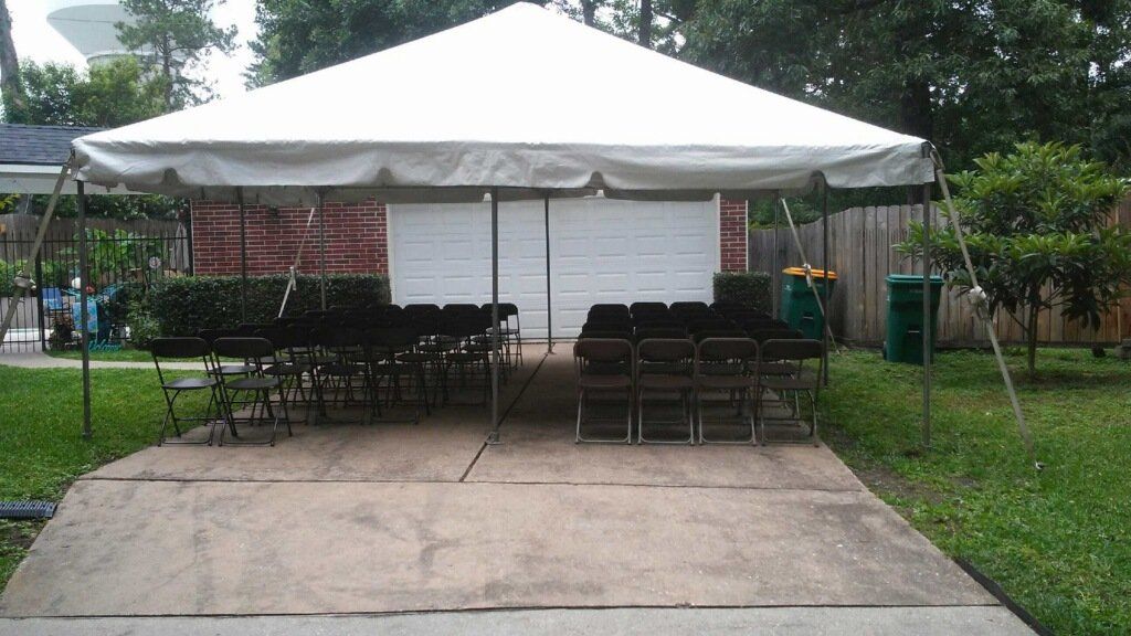 outdoor tent setup with black chairs