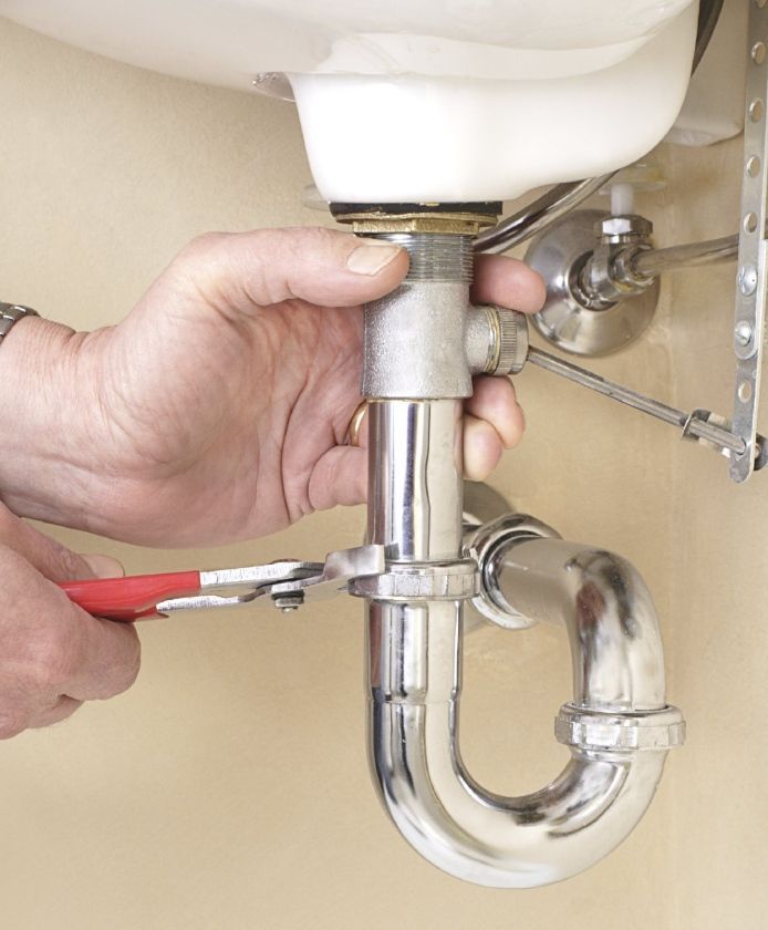 close up photo of a sink trap repair under the sink