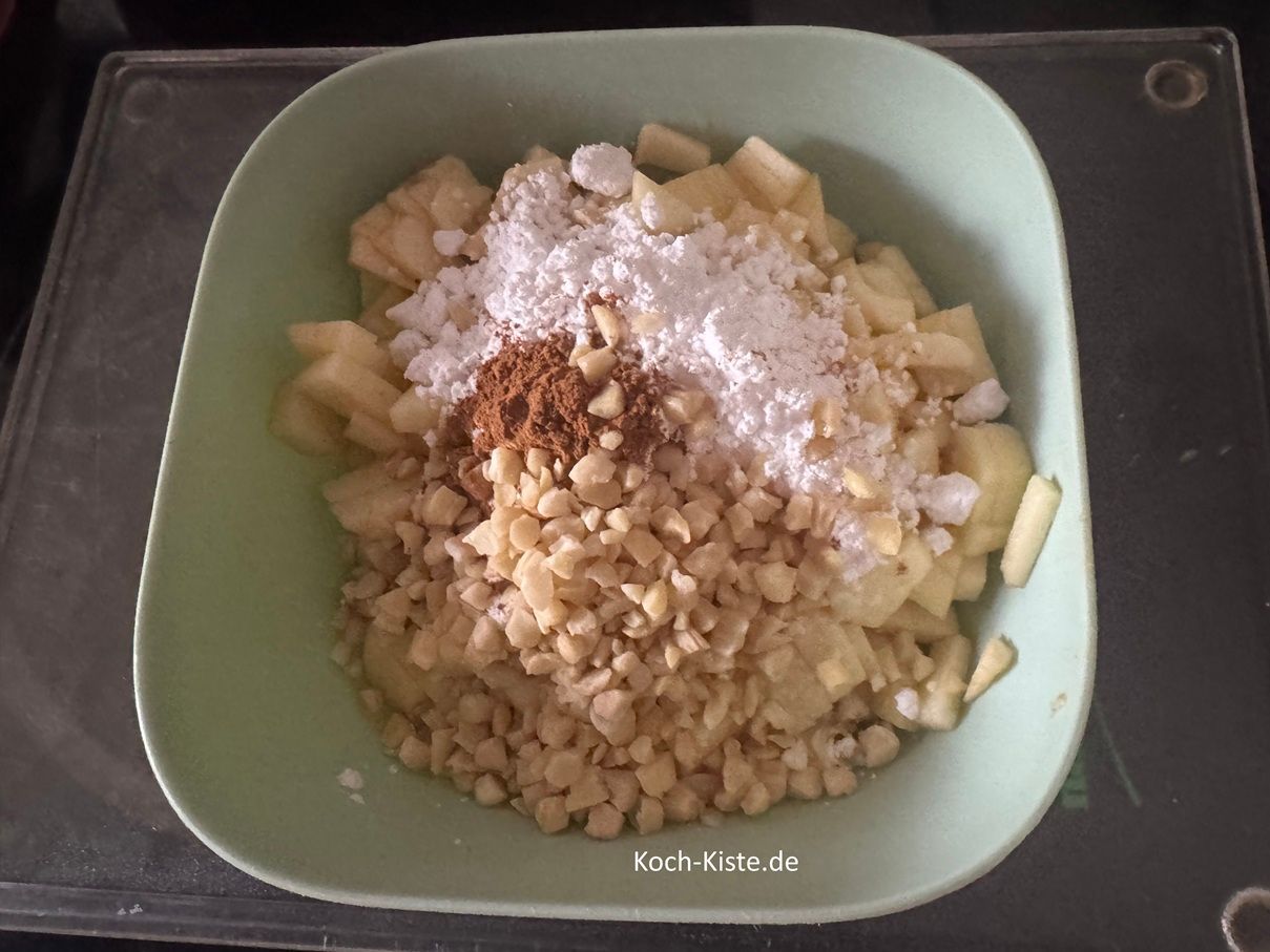 Dann stelle die Apfelschüssel auf die Küchenwaage - auf 0 und wiege 30 g gehackte Mandeln hinein.