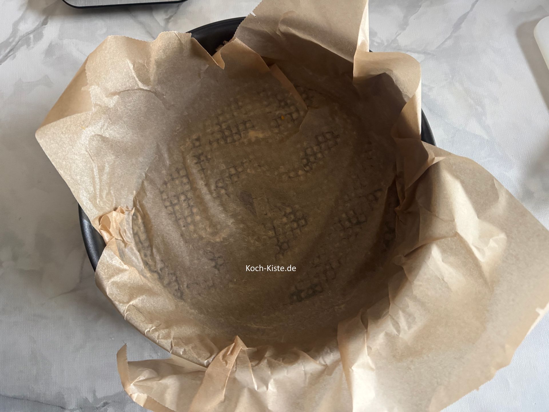 dann werden 2 Bögen Backpapier in die Springform gelegt - versetzt, so das die ganze Springform mit Backpapier bedeckt ist