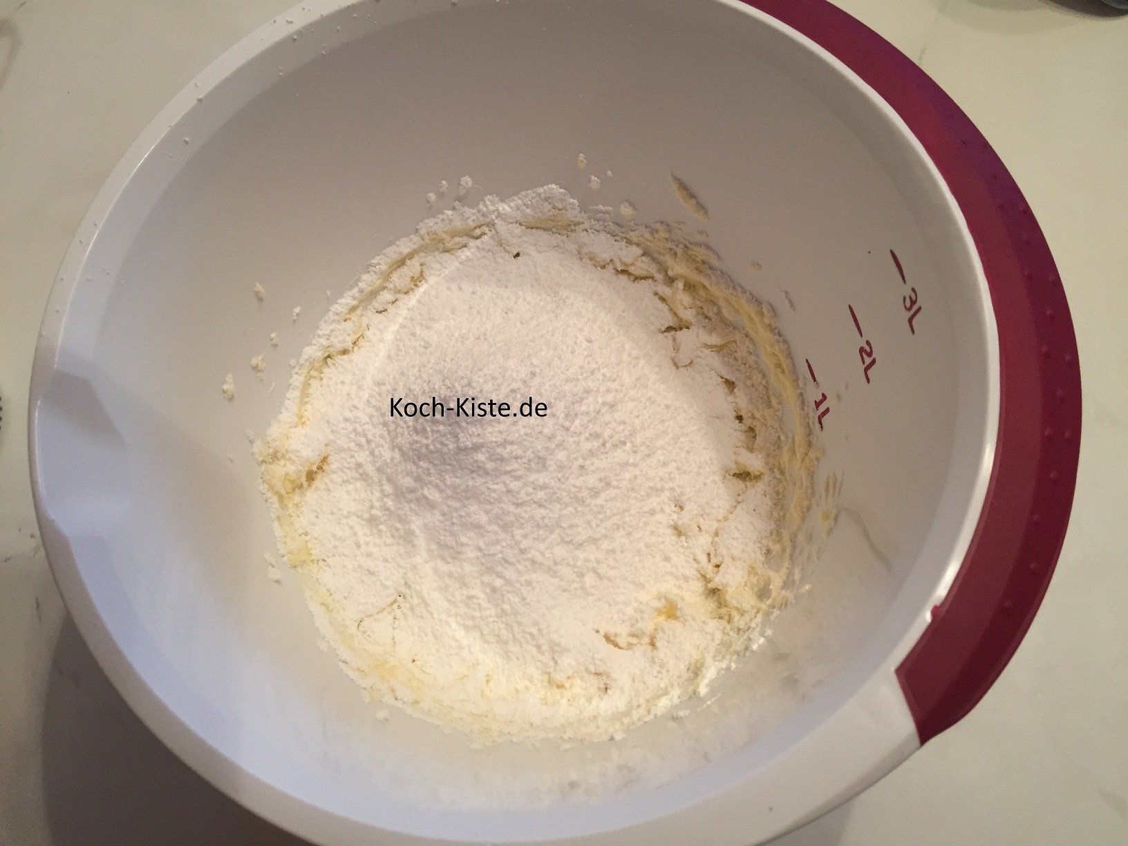 Puderzucker in die Rührschüssel sieben