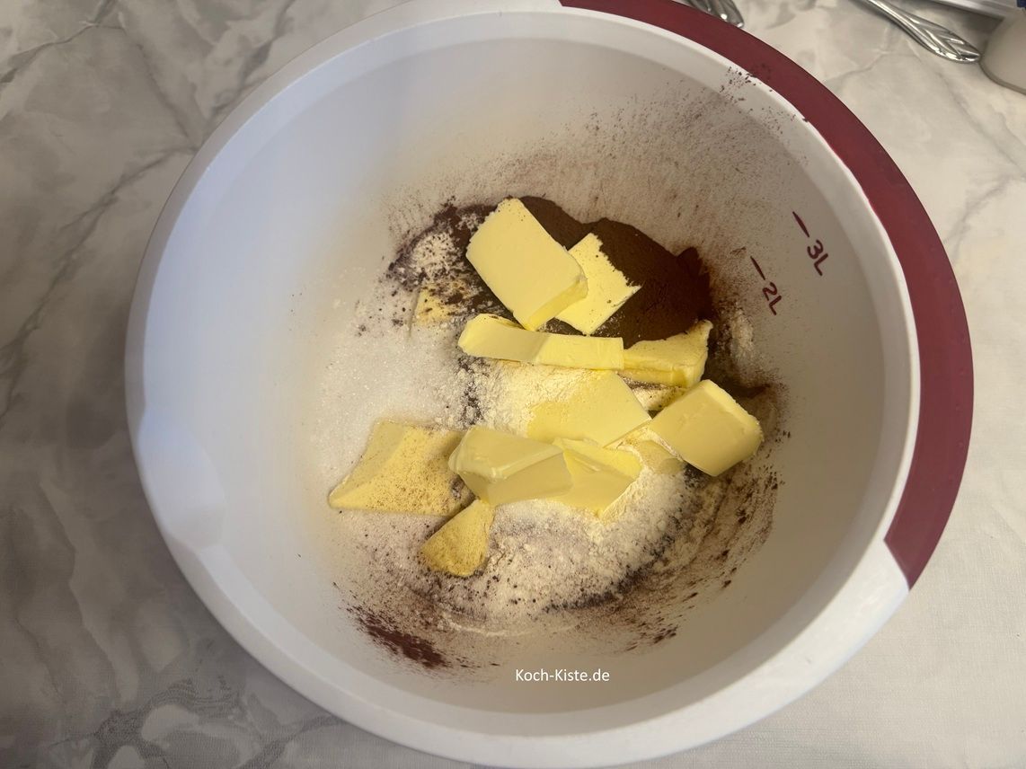 dann stelle die Rührschüssel wieder auf die Küchenwaage - auf 0 und schubse mit einem Messer 200 g kalte Butter hinein