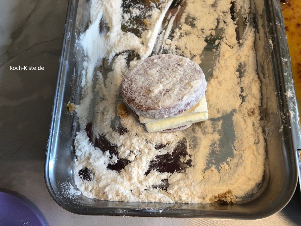 wende das Salamistück von allen Seiten in Mehl