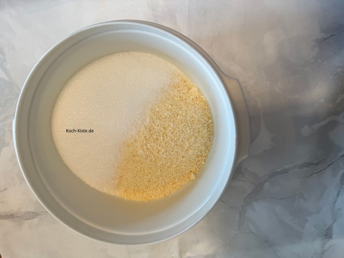 stelle die extra Schüssel auf die Küchenwaage auf 0 , wiege 150 g Zucker hinein, dann Küchenwaage wieder auf 0 stellen und 120 g Kokosflocken hinein wiegen