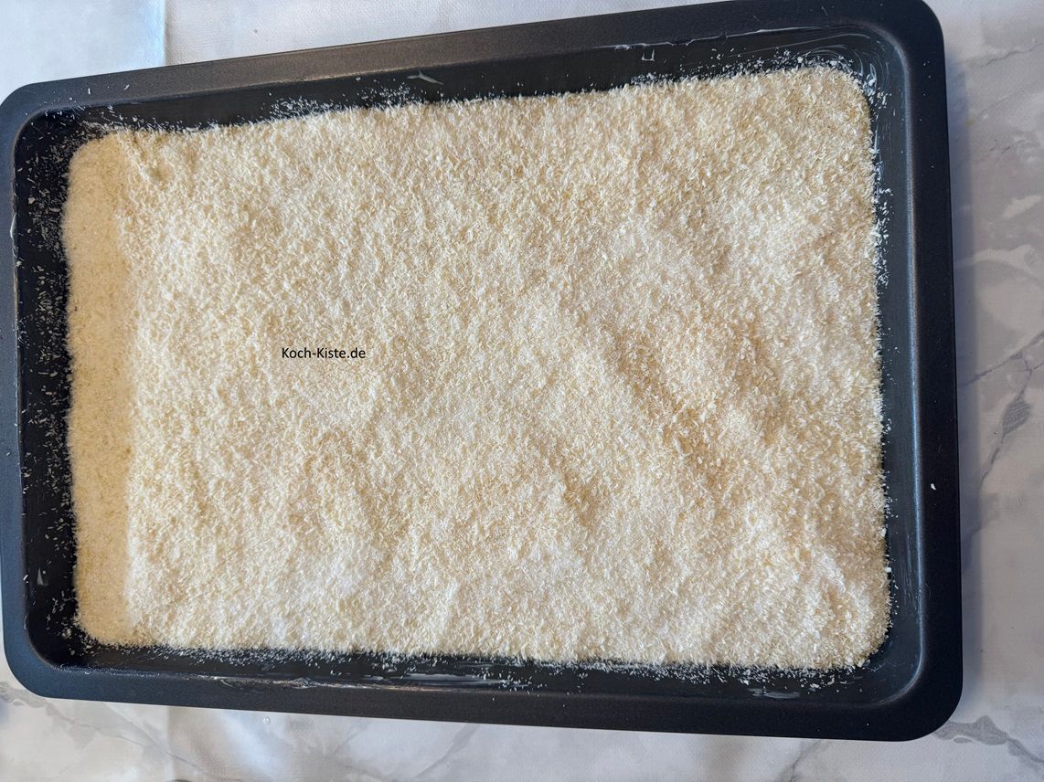 als nächstes verteile die Kokos-Zucker Mischung gleichmäßig auf dem Teig. Nun kommt der Kuchen in die mittlere Schiene des Backofens und wird 25 Minuten gebacken