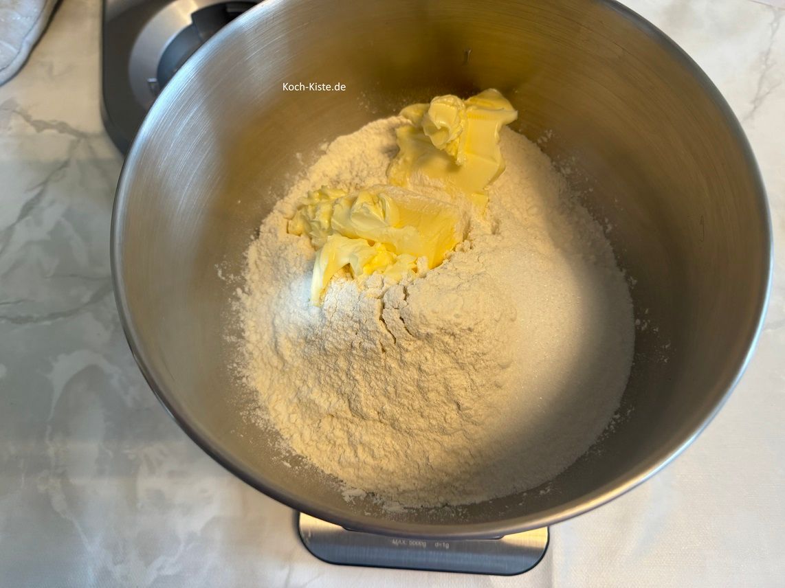 dann stelle die Küchenwaage wieder auf 0 und schubse mit einem Tafelmesser 130 g weiche Butter hinein