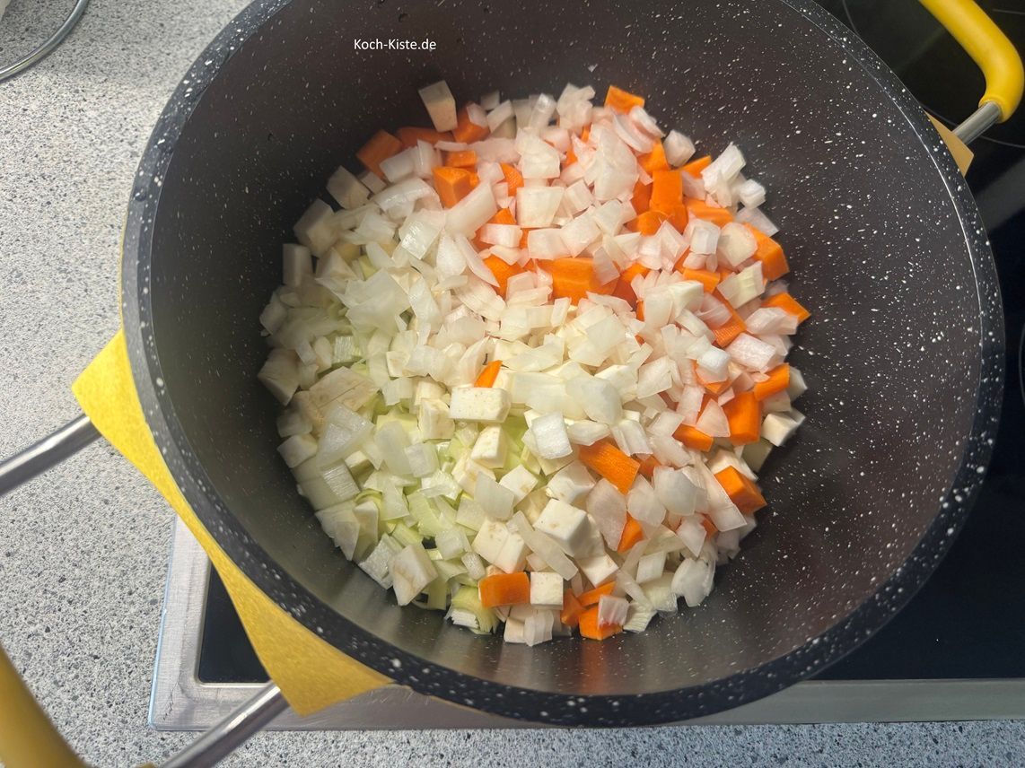 Selleriestücke, Wurzelstücke und Zwiebelstücke mit in den Topf und brate sie kurz an.
