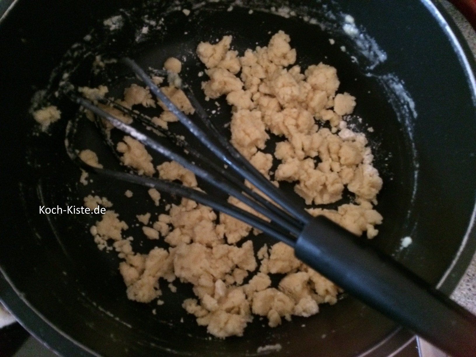 schütte unter ständigem Rühren mit dem Schneebesen, schubsweise Mehl hinzu. So lange bis das Mehl krümelig wird.