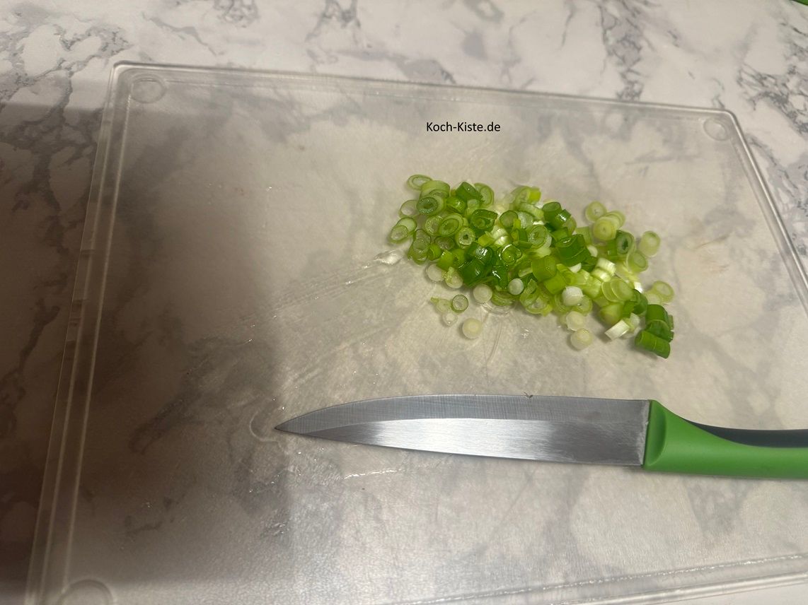 schneide die Lauchzwiebel in kleine Ringe