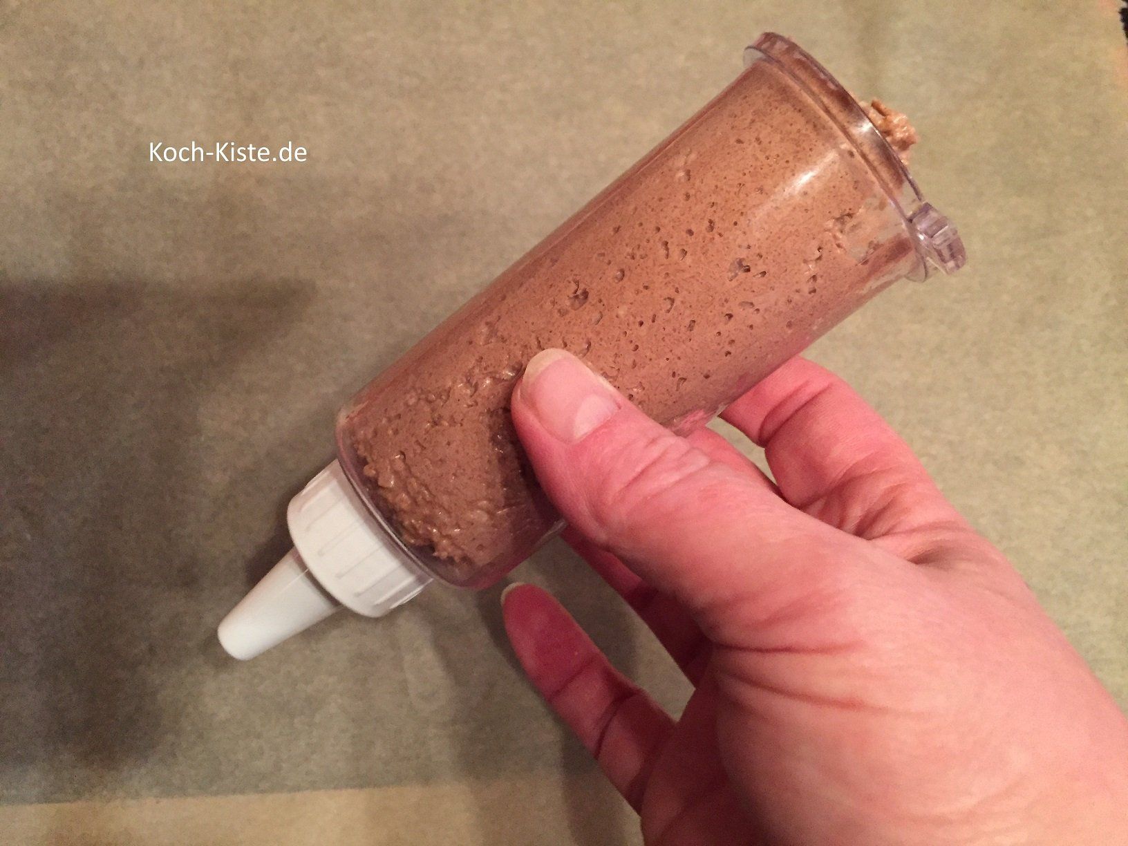 Plätzchenteig in eine Gebäckpresse füllen