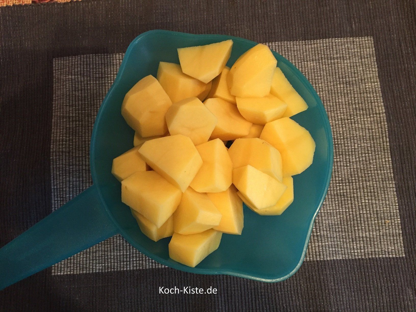 Kartoffeln unter fließendem , kaltem Wasser abspülen und halbieren bzw. vierteln