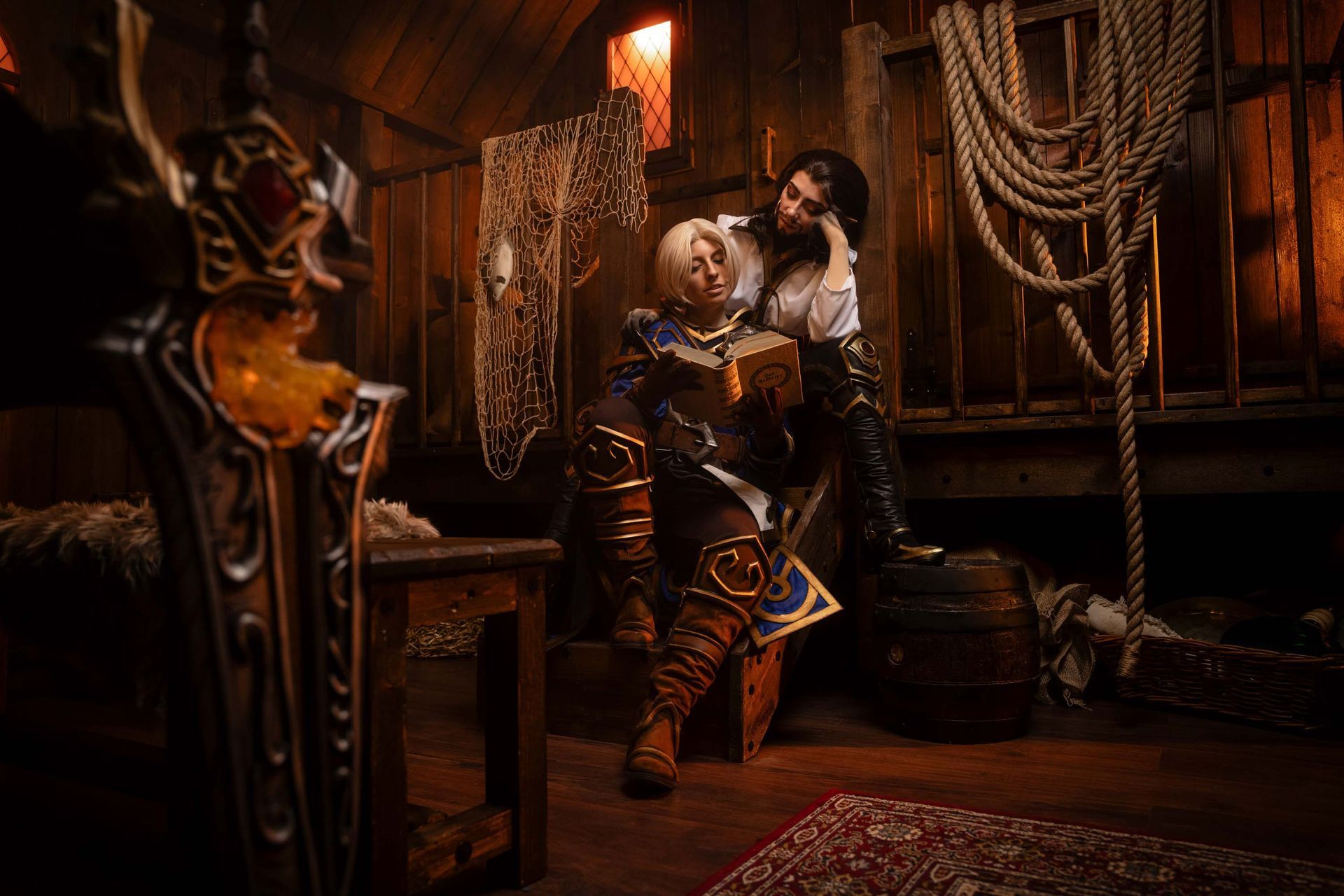Zwei World-of-Warcraft-Charaktere stehen eng beieinander in einer hölzernen Taverne