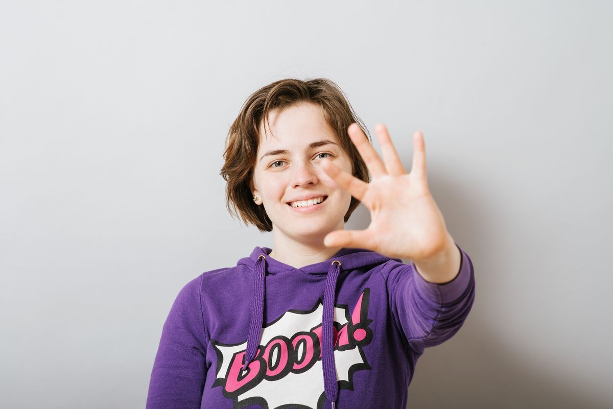 A young teen wearing a purple hoodie with 