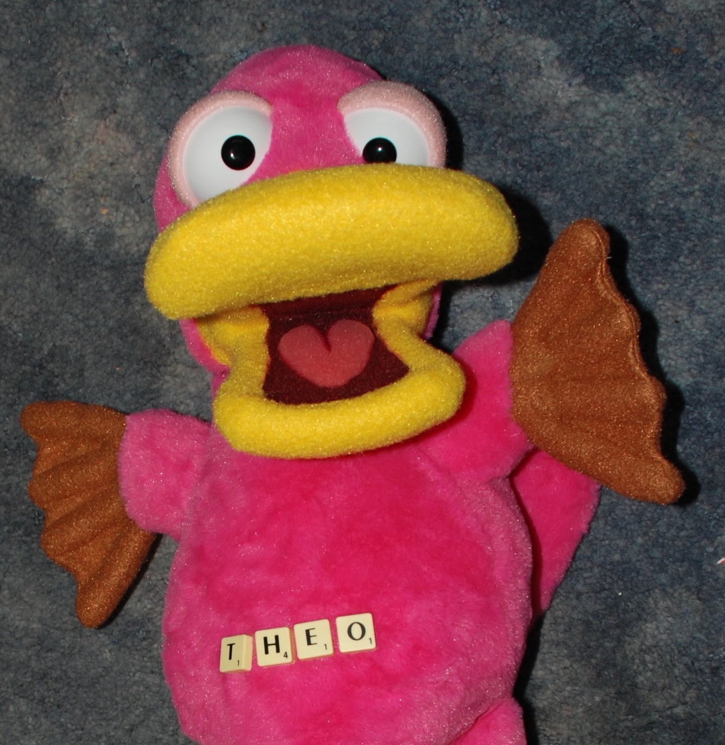 Theo Platypus with scrabble tiles on his tummy. They spell his name.