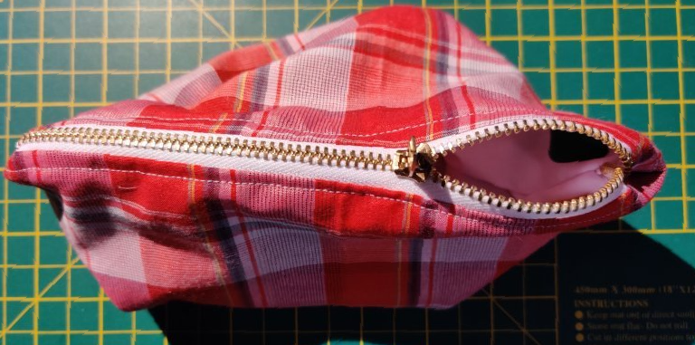 A red tartan pencil case with a zip