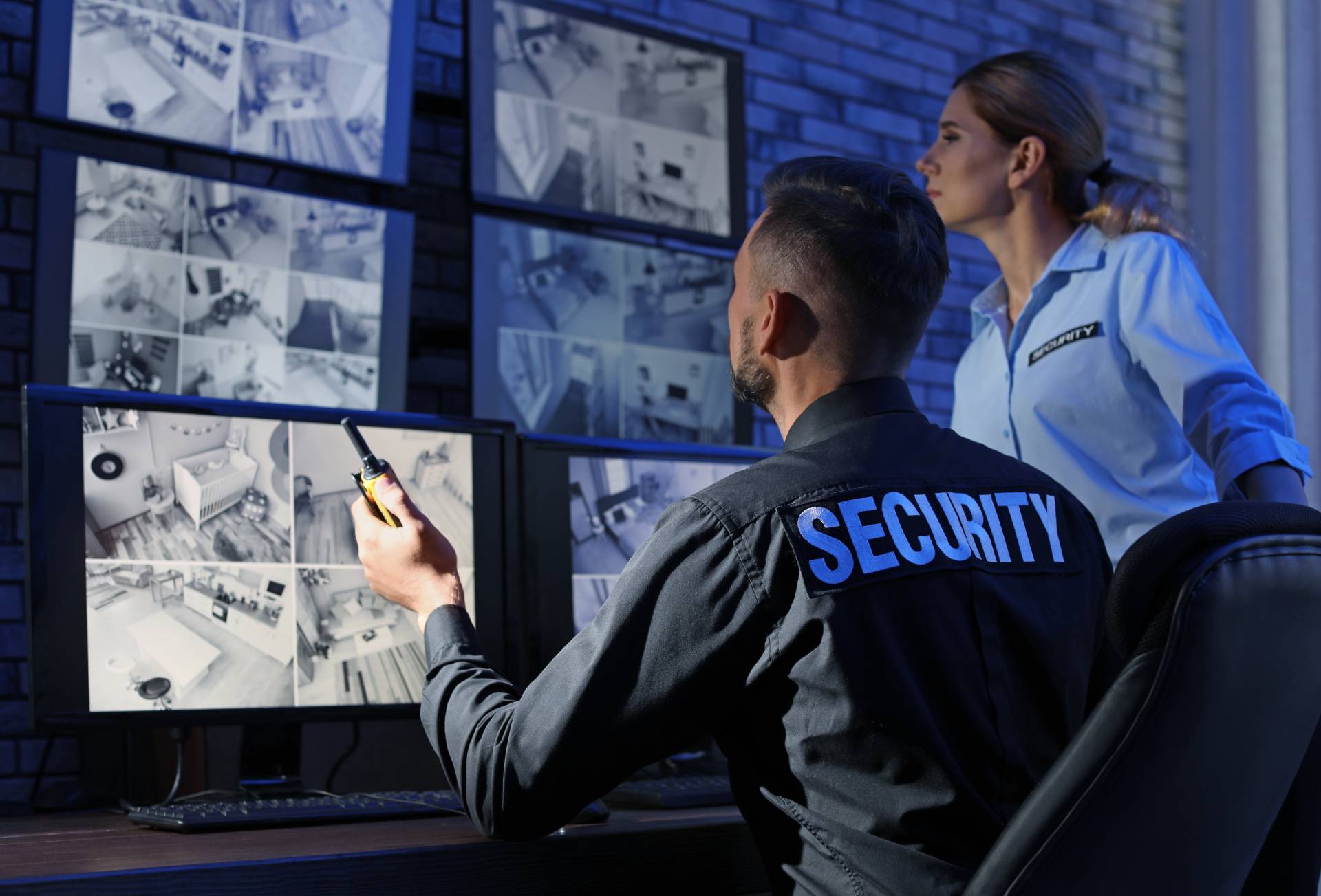 image of a security guy looking at security cameras