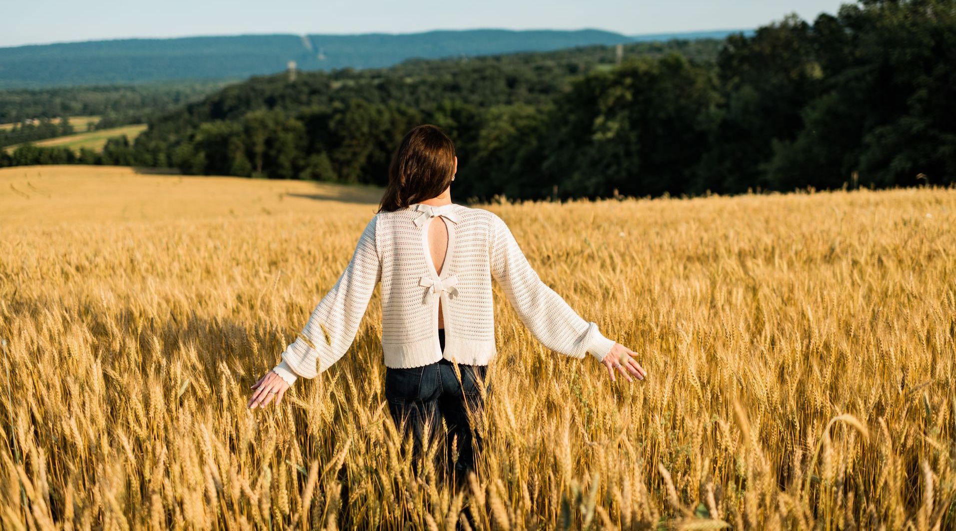 Shaunna Huhnke in a wheat field, owner of Farmer Girl Web Design