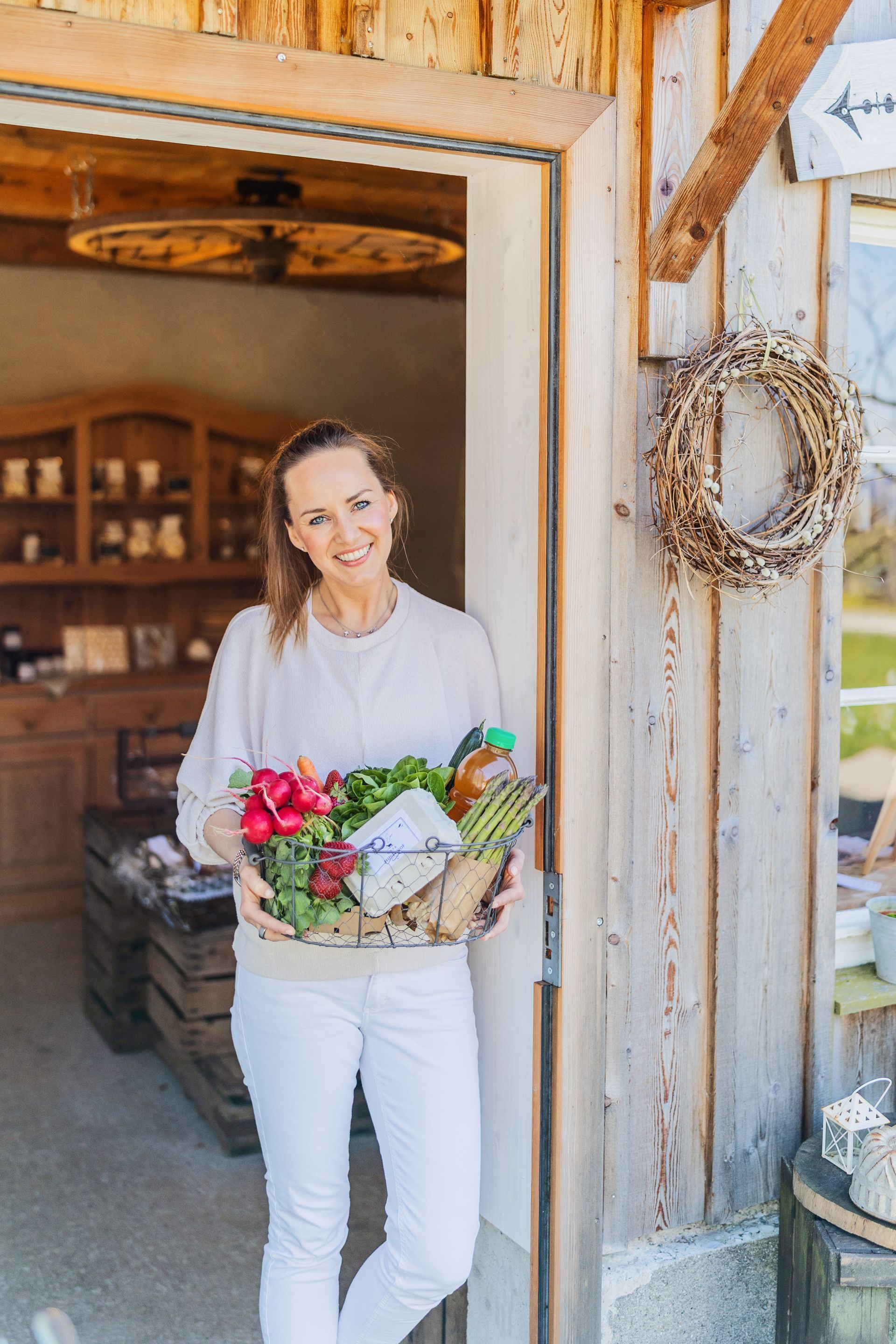 Holistic health and lifestyle coach holding fresh vegetables to promote energy and well-being