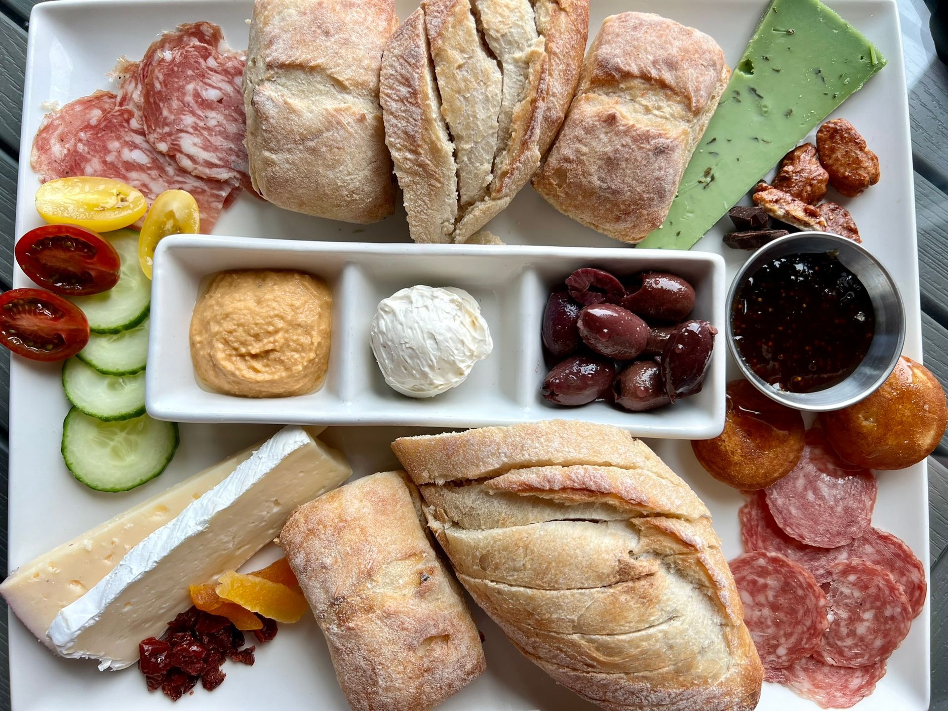 The Vintner's Plate, priced at $31.00, is a curated selection of artisan cheeses, fresh bread, local meats, and delectable accompaniment