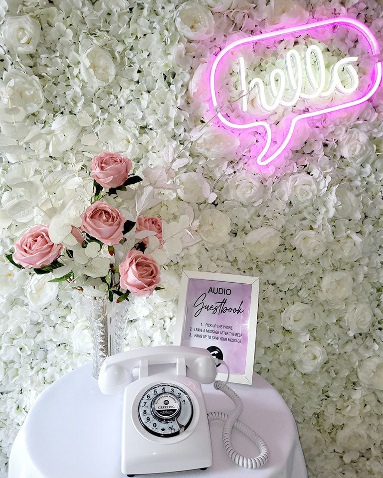 Audio Guestbook with white flower wall backdrop