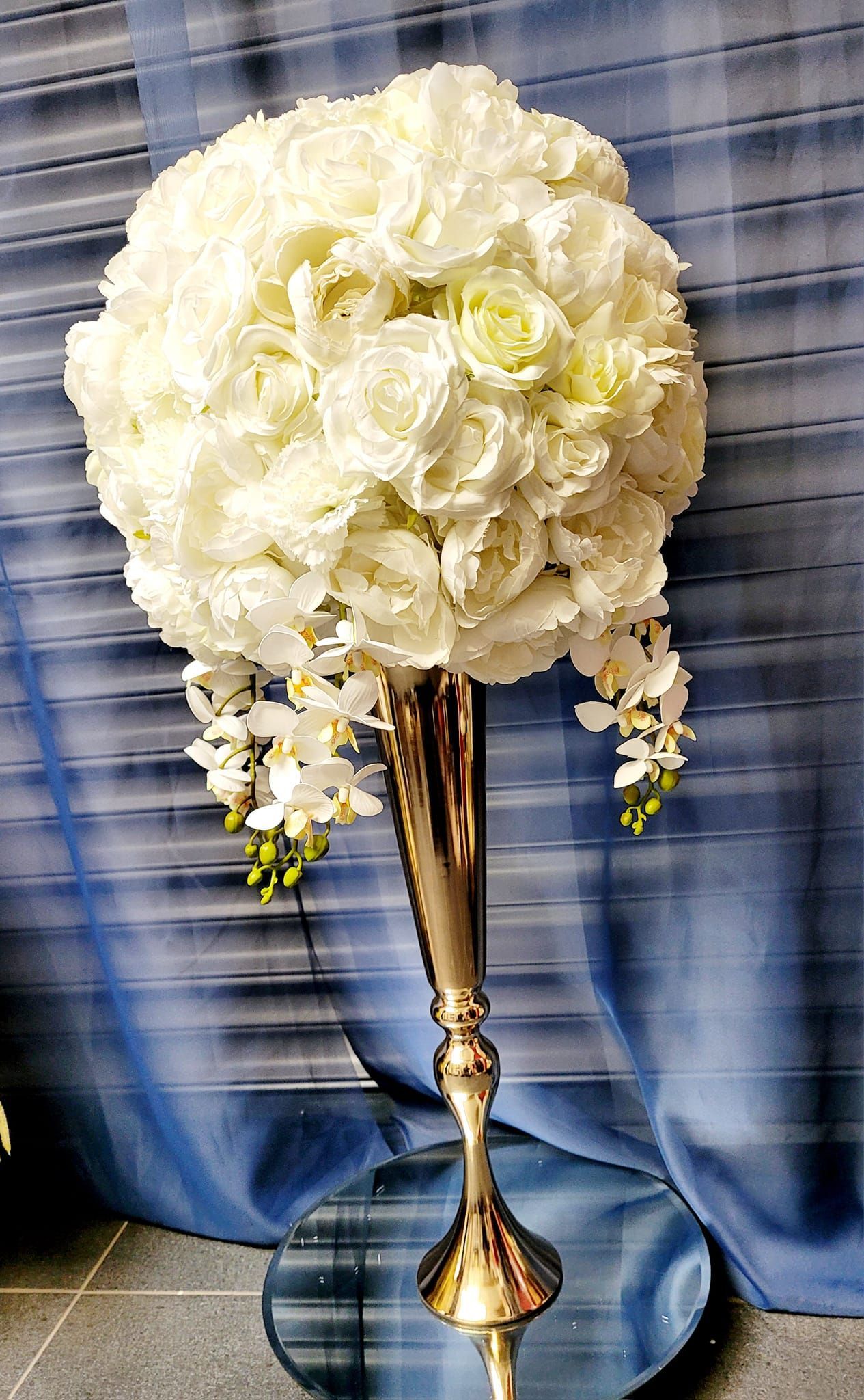 Gold trumpet vase with large flower ball arrangement