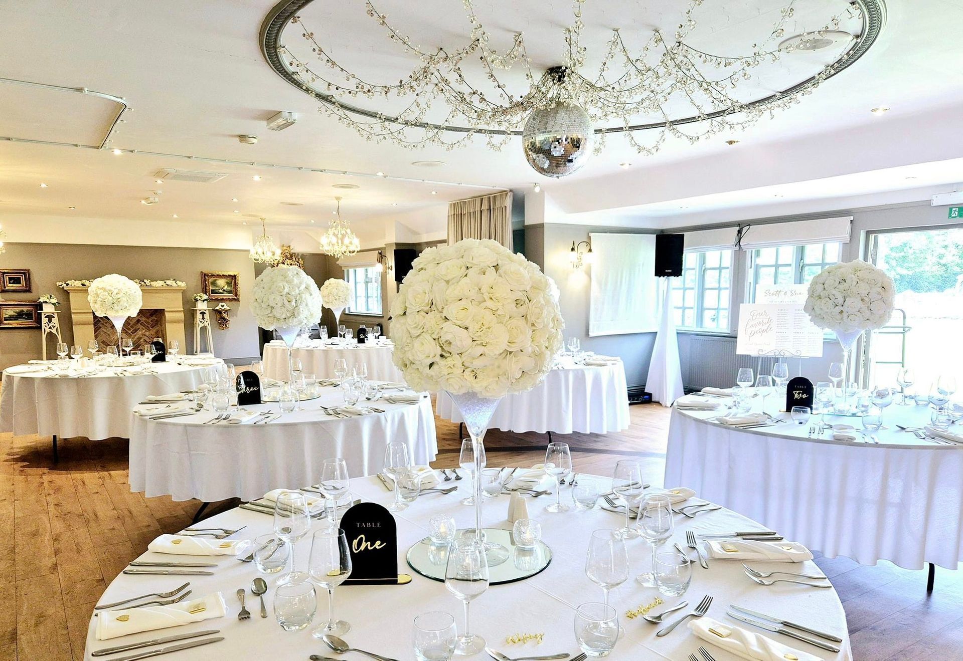 Luxurious white flower ball centrepieces.