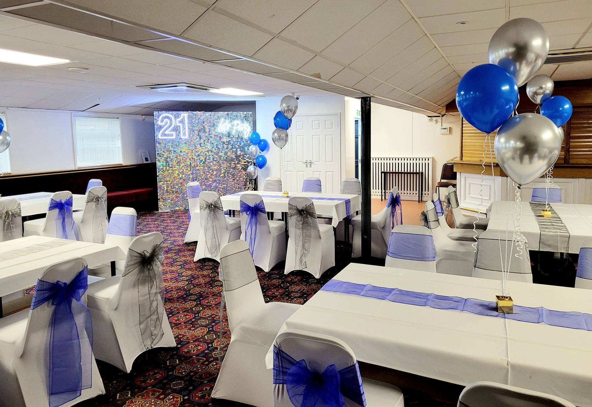 Party venue styling featuring illuminated props and themed decorations.