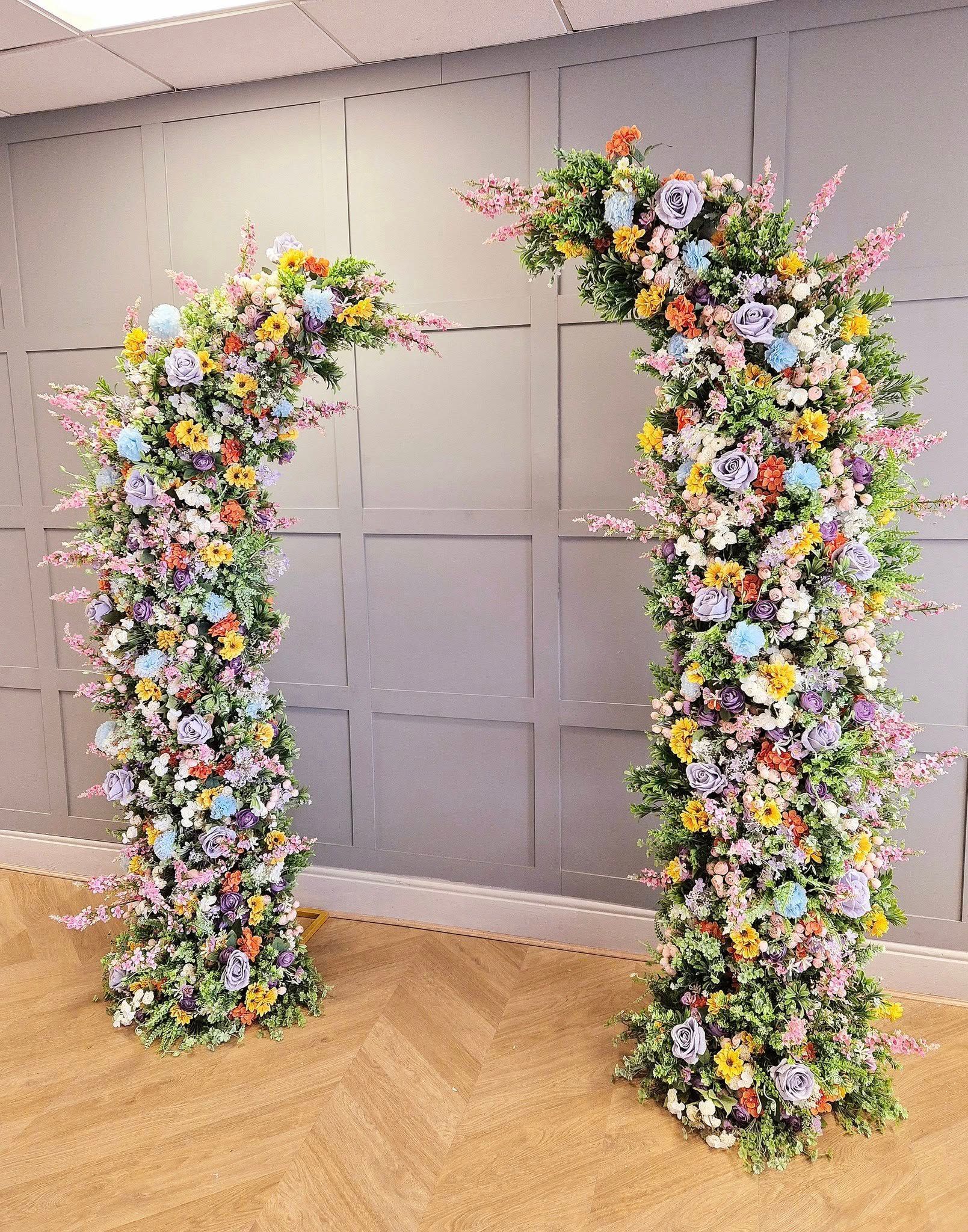 White luxe moongate arch filled with roses.