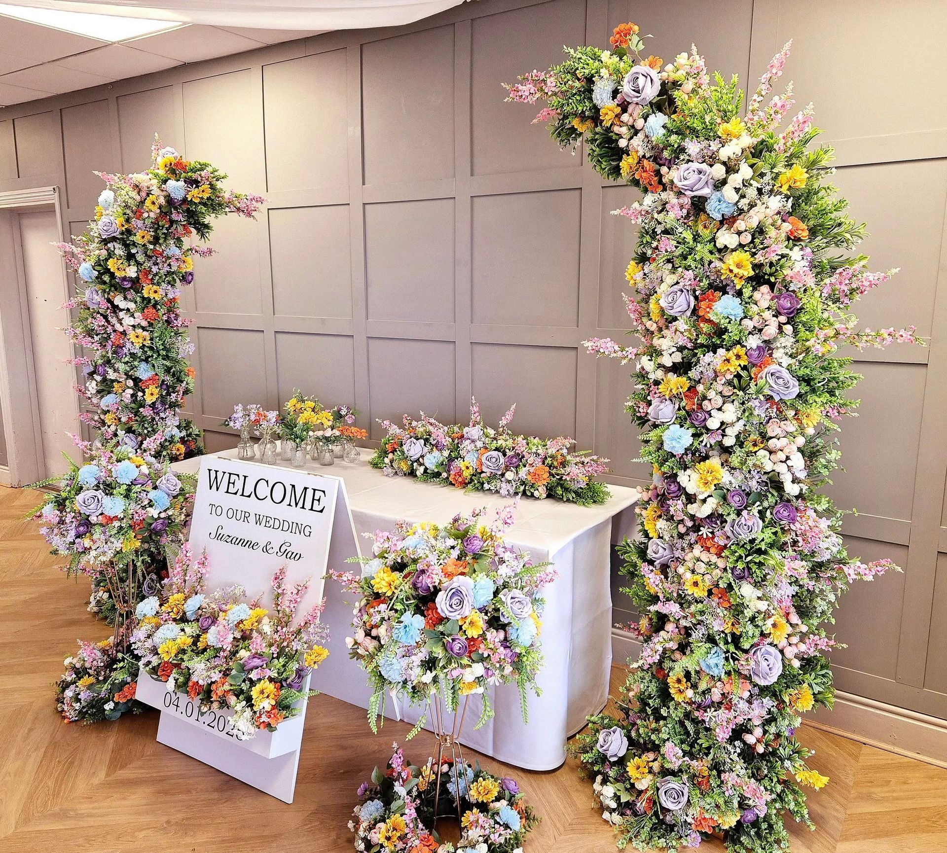 Til death do us party neon sign on green foliage flower wall creating a backdrop.