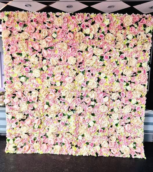 Flower wall with Til death do us party neon sign attached