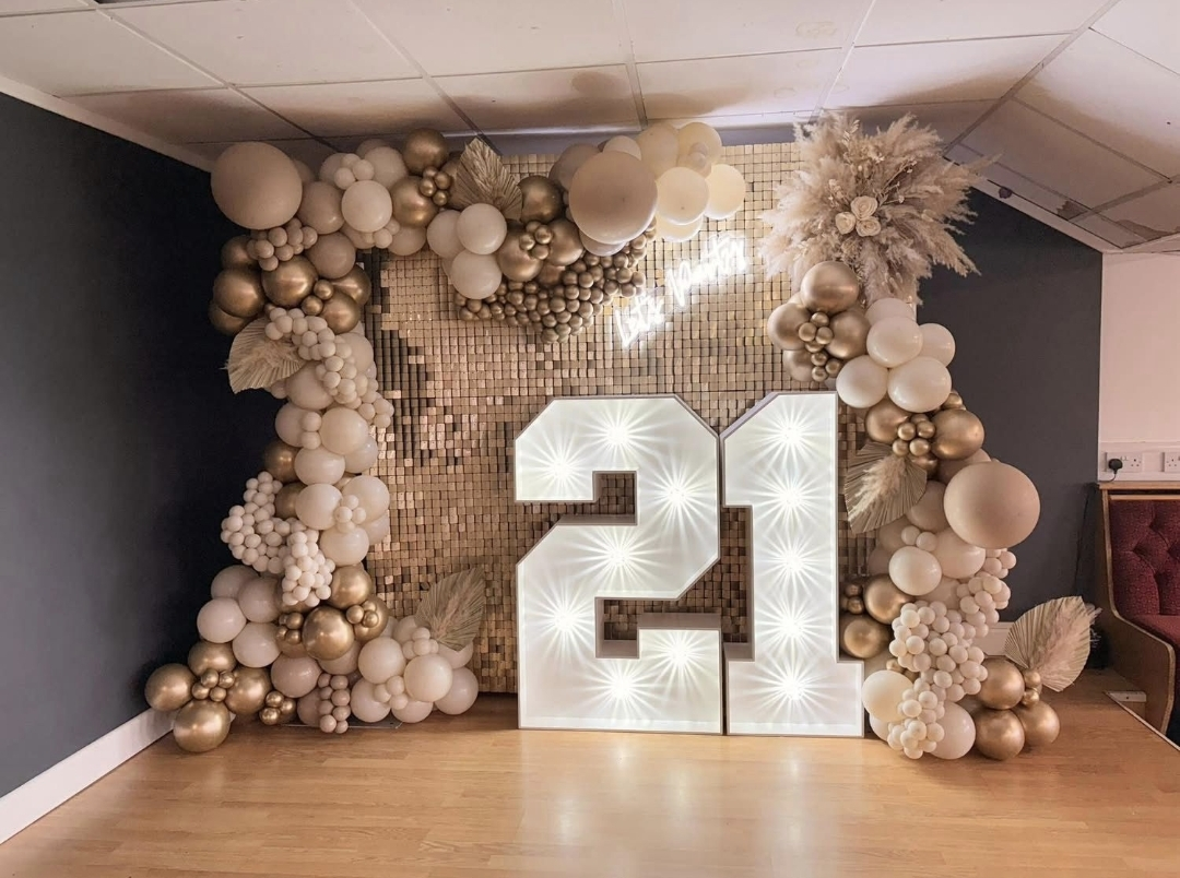 Number 21 light up letters with sequin wall and balloon garland