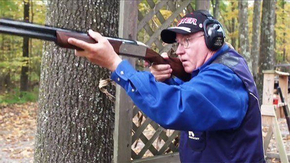 Person aiming a shotgun