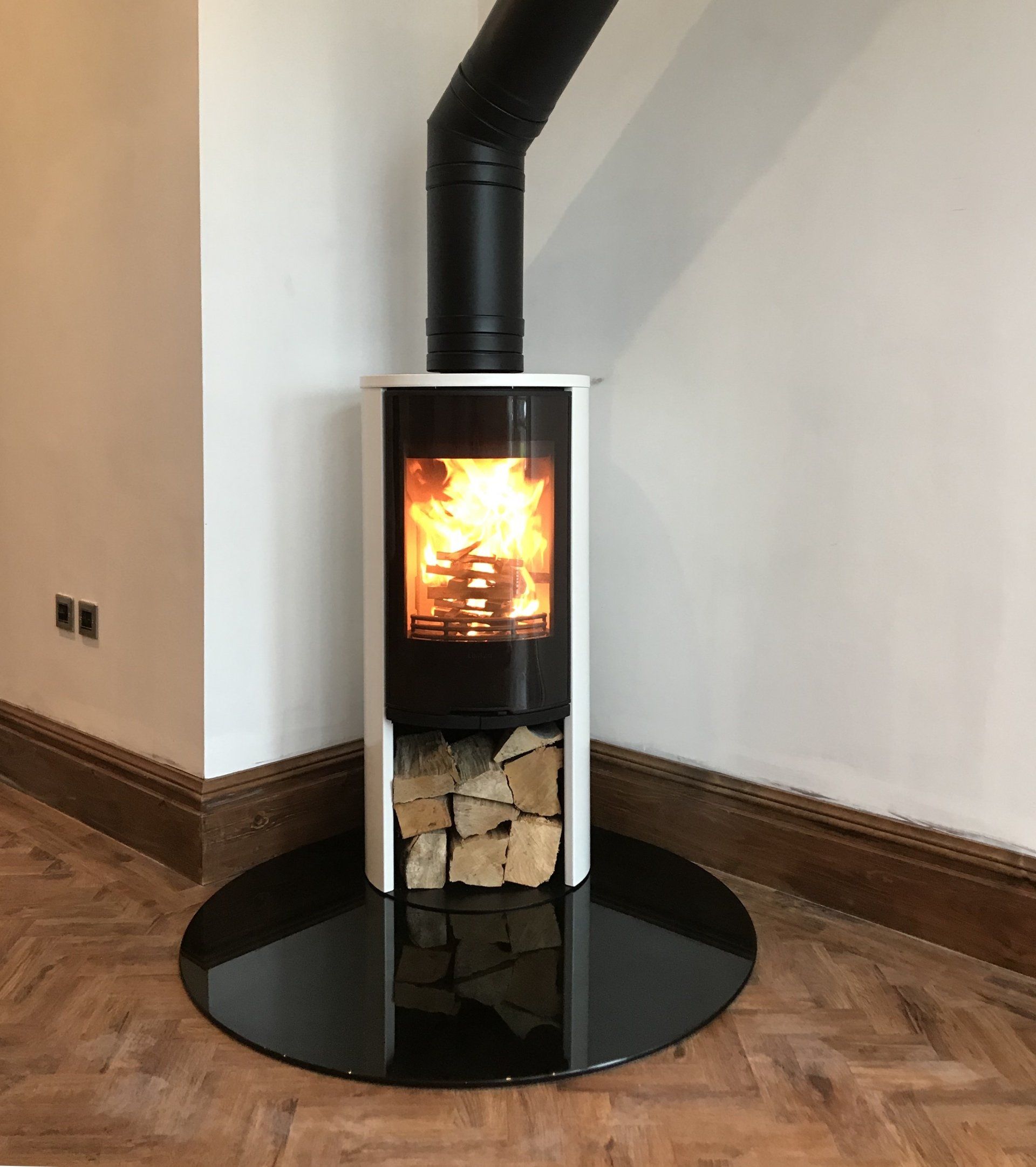 Twinwall flue chimney system with a glass hearth and a  Contura free standing defra approved log burning stove
