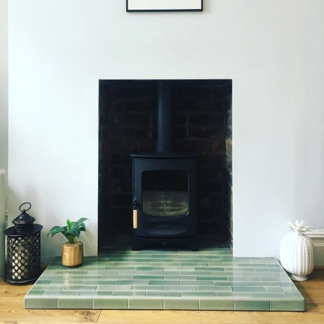 Brickwork chamber with a quarry tiled hearth and a Charnwood defra approved multifuel stove