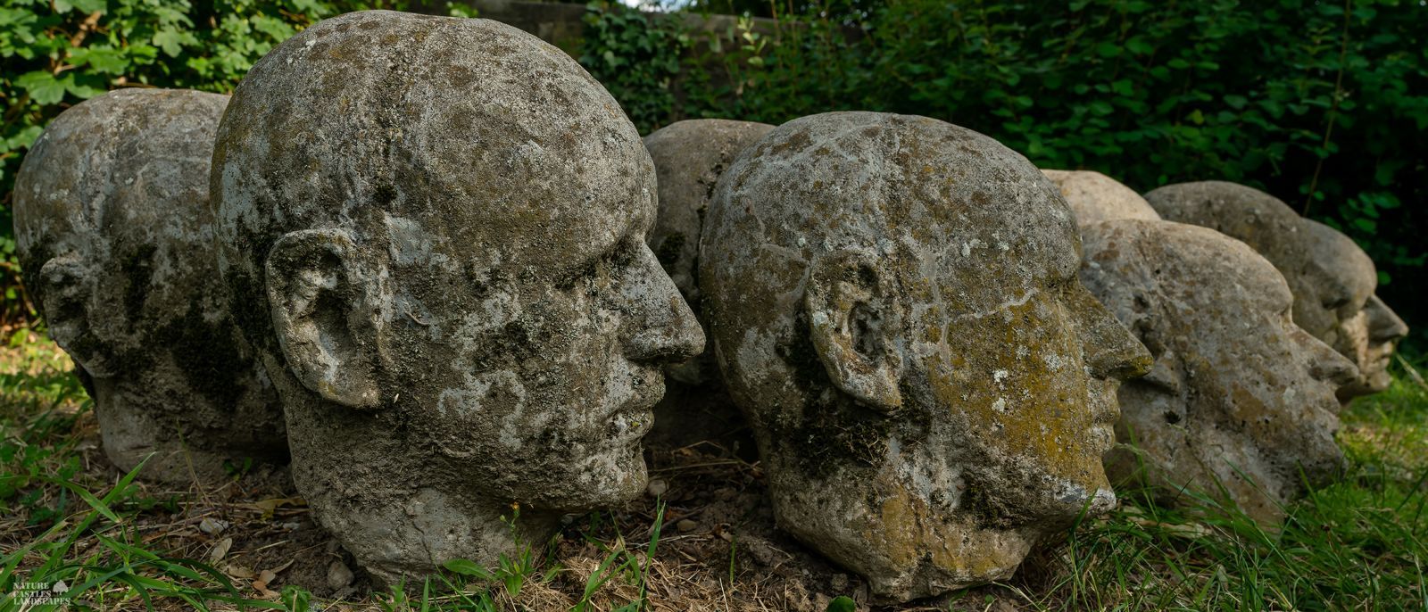concrete heads as art on a graveyard