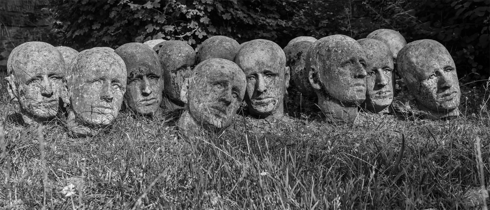 concrete heads as art on a graveyard in germany