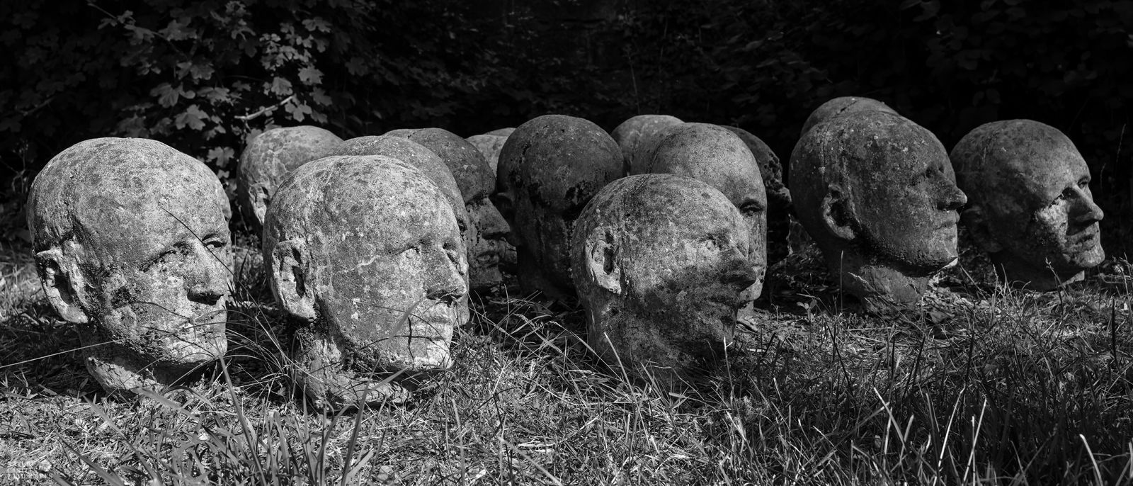 concrete heads as art on a graveyard at the city of bochum