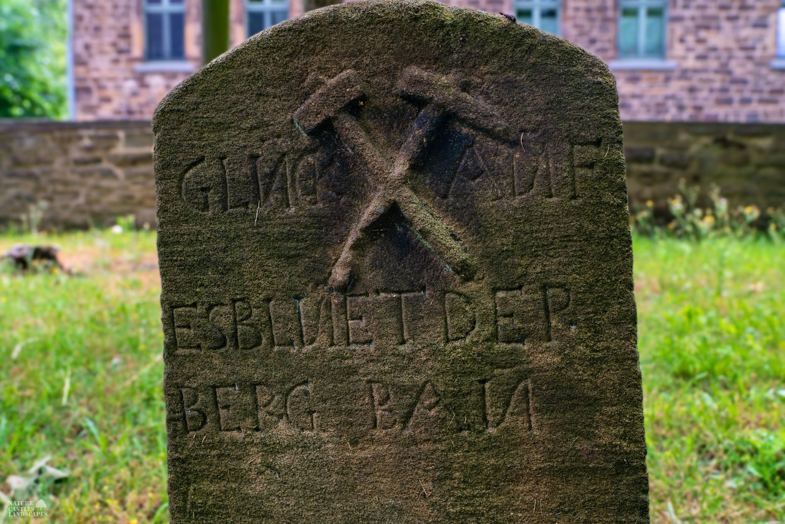 mining insignia on a historic tombstone