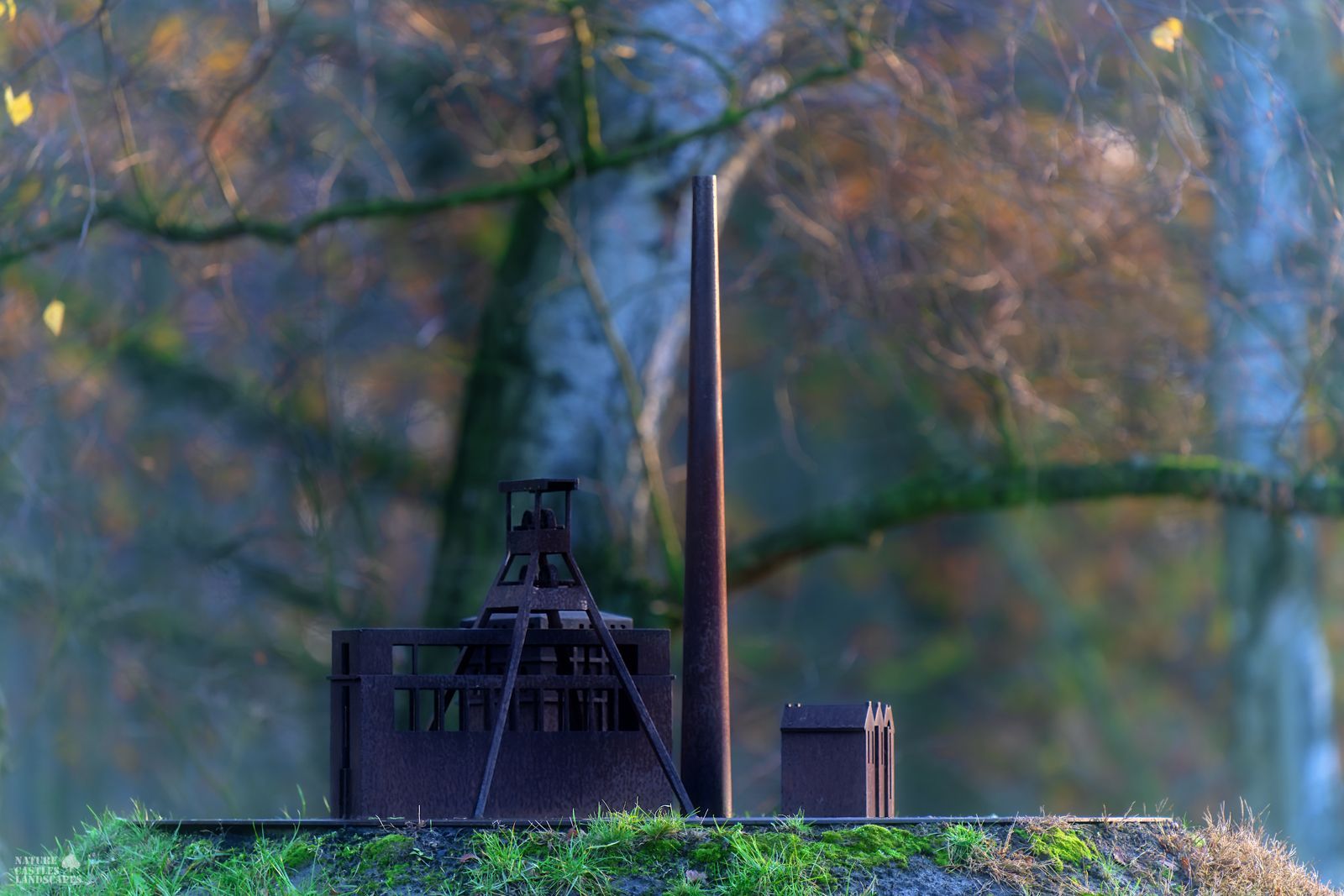rusty metal model of a colliery at sunset