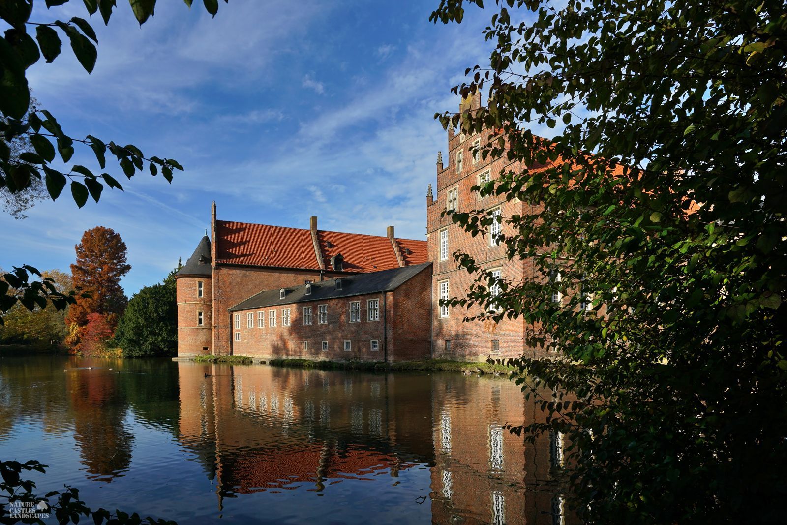 picture of the moat at herten castle at autumn