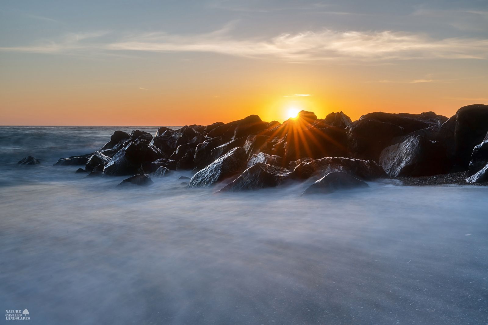 Danish North Sea coast summer solstice behind rocks