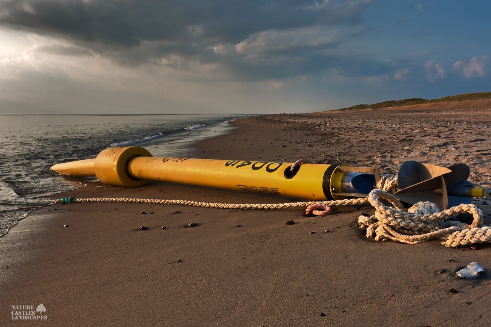 jetsam and flotsam on the Danish North Sea coast a yellow buoy