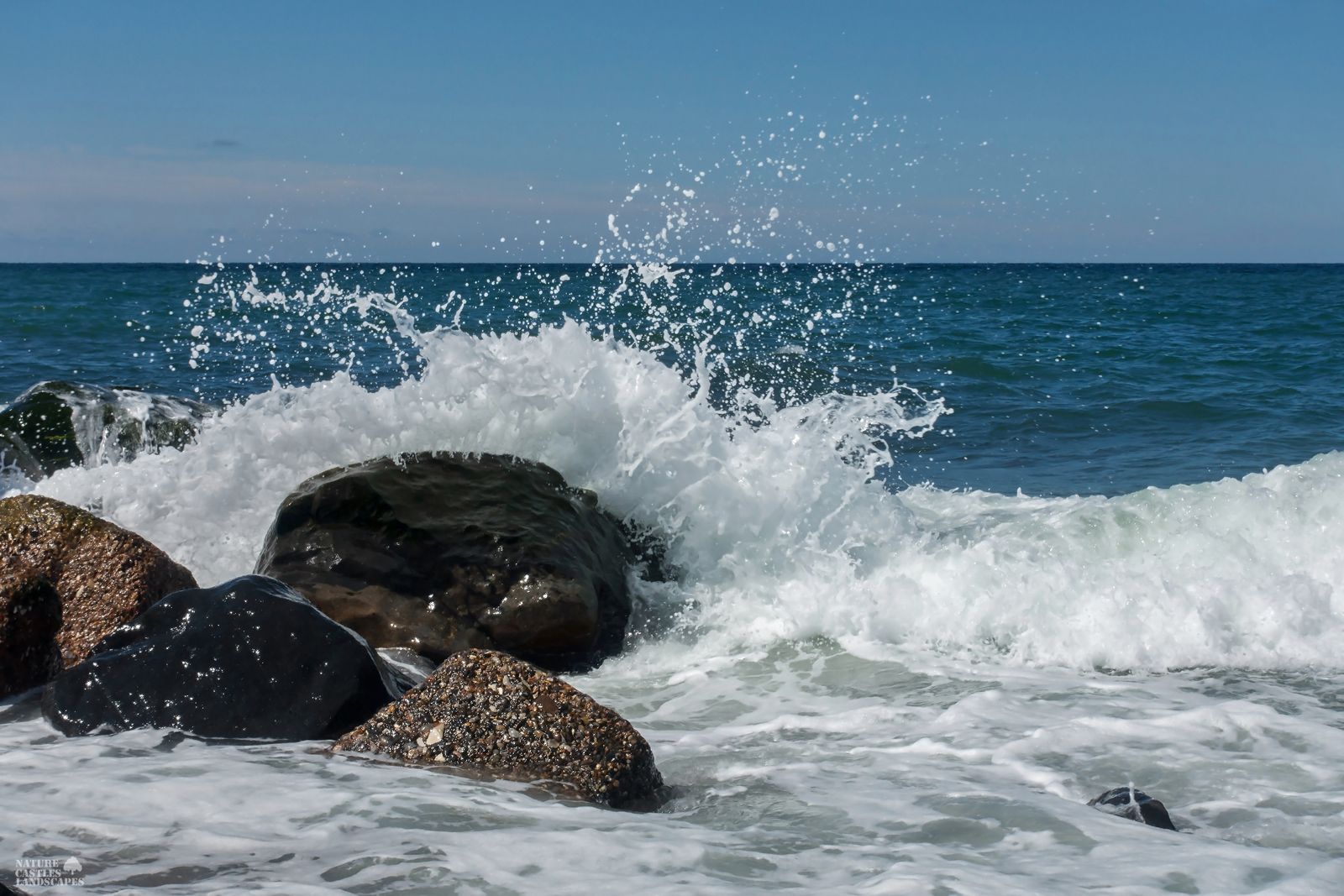 Danish North Sea coast waves wash over a stone