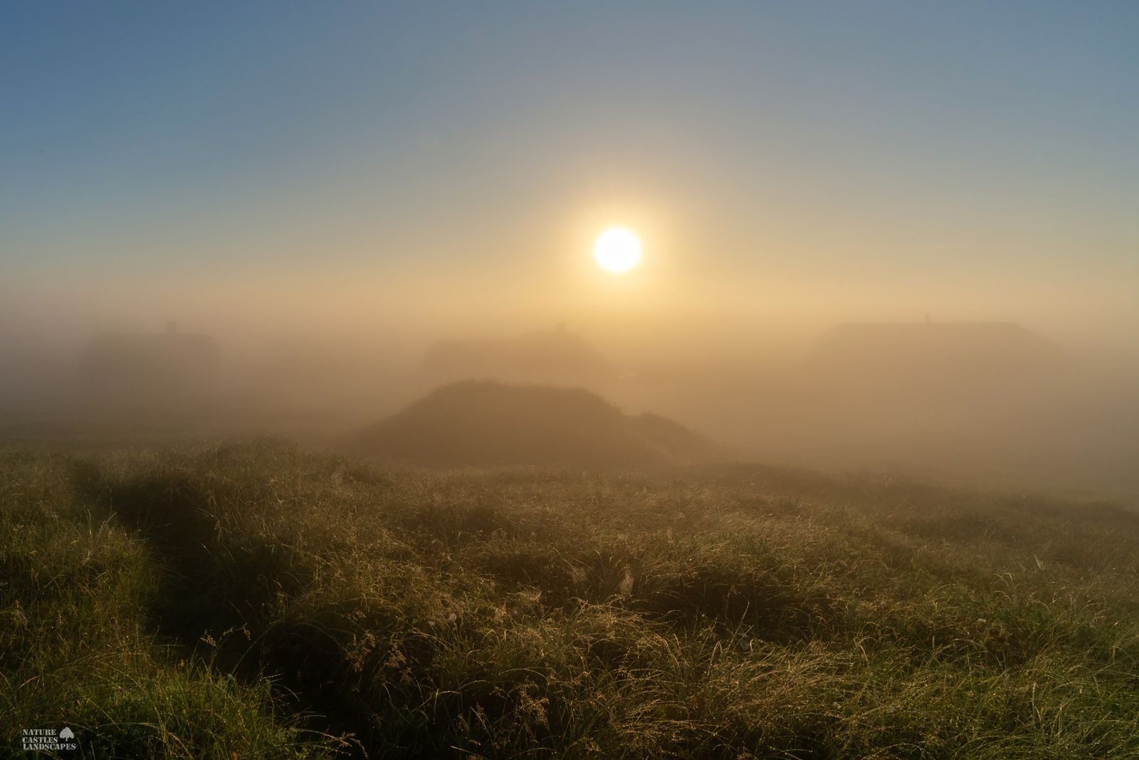 Sunrise over the holiday home settlement on the Danish North Sea coast in the fog